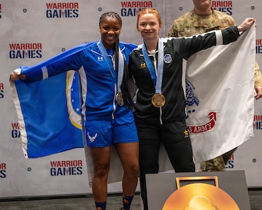 Retired U.S. Air Force Senior Airman Crystal Creek, left, and U.S. Army Staff Sgt. Chelsey Scott celebrate following the powerlifting competition at the 2026 Warrior Games at the Henry B. González Convention Center in San Antonio.