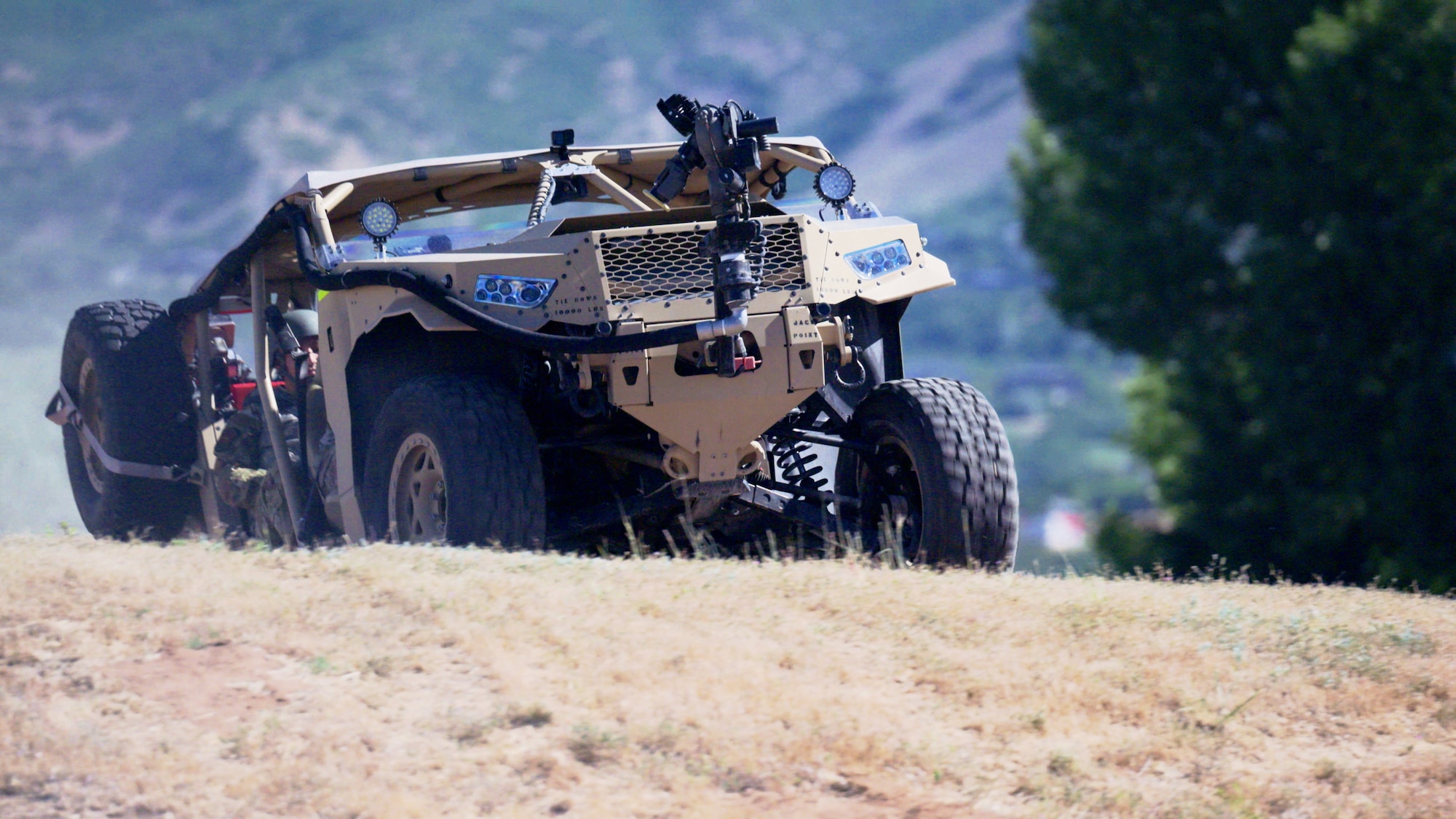 The MARK 1 crests a grassy hill.