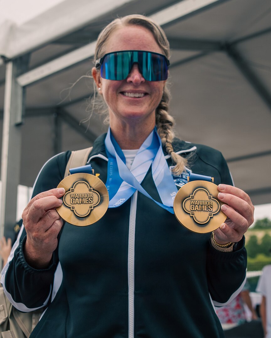 U.S. Army Maj. Mandy Feindt displays her gold medals after the cycling event during the 2026 Warrior Games in San Antonio.