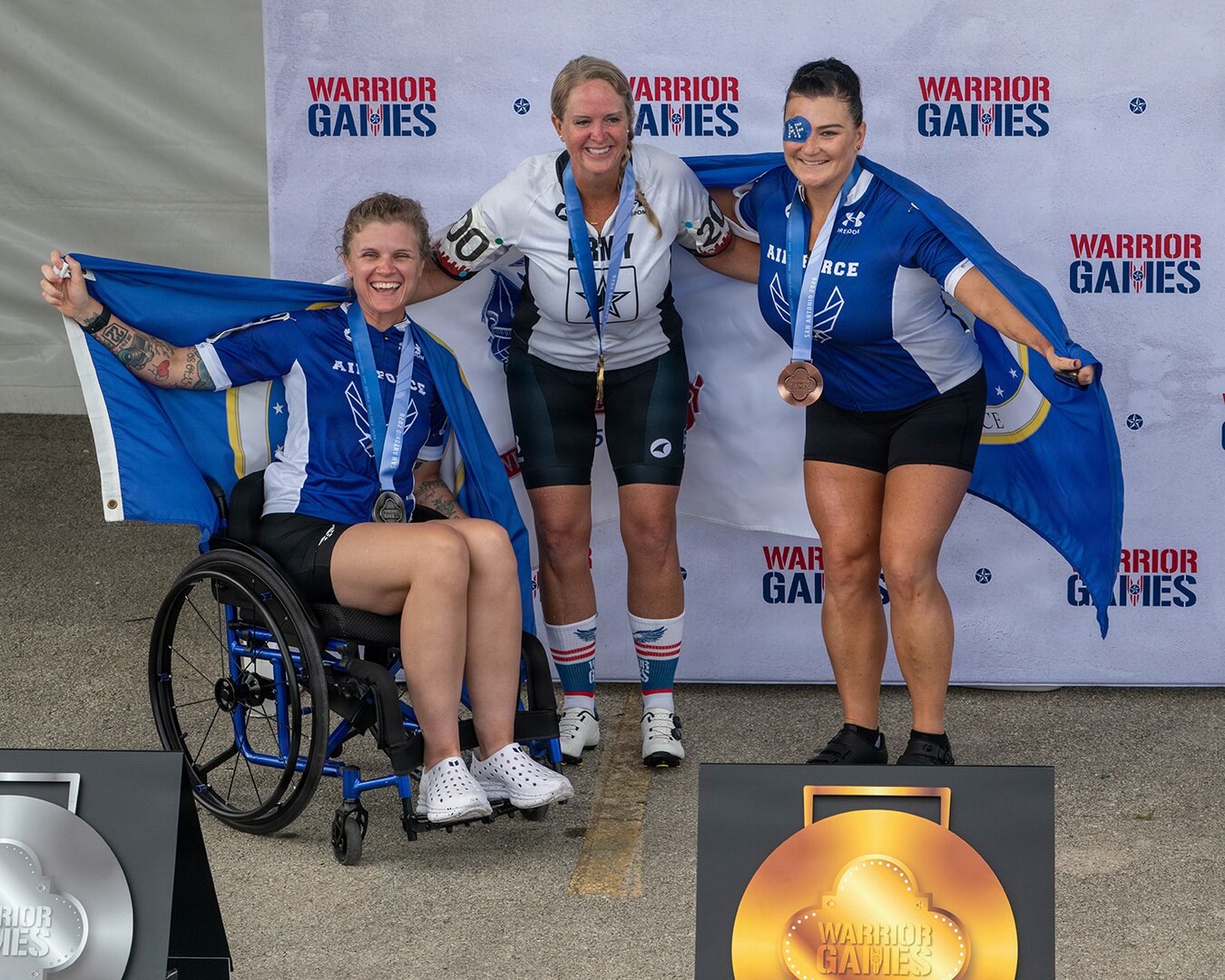 Retired U.S. Air Force Staff Sgt. Allison Smith, left, U.S. Army Maj. Mandy Feindt, center, and retired Chief Master Sgt. Danielle Spurlock, right, celebrate after earning gold medals during the 2026 Warrior Games in San Antonio.