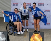 Retired U.S. Air Force Staff Sgt. Allison Smith, left, U.S. Army Maj. Mandy Feindt, center, and retired Chief Master Sgt. Danielle Spurlock, right, celebrate after earning gold medals during the 2026 Warrior Games in San Antonio.