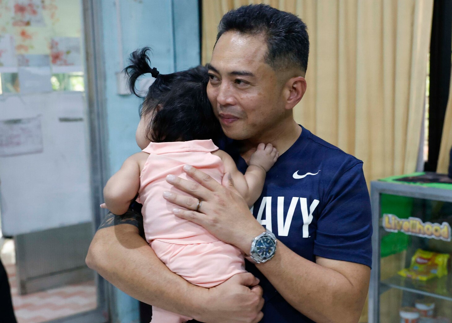 OLONGAPO CITY, Philippines (June 12, 2026) – U.S. Navy Capt. Robert Reyes, mission commander of Pacific Partnership 2026 (PP26), holds a child during a PP26 community outreach and engagement event at the Olongapo Social Development Center in Olongapo City, Philippines, June 12, 2026.