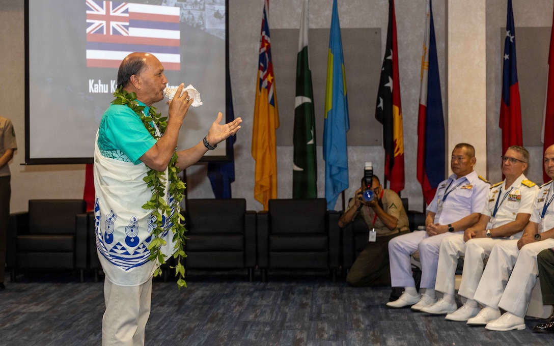 Kordell C. L. Kekoa, a Hawaiian minister, delivers a Hawaiian blessing during the opening ceremony of the Pacific Amphibious Leaders Symposium 2026 in Honolulu, Hawaii, June 16, 2026. Bringing together experts and leaders from across the Indo-Pacific, PALS fosters collaboration among allied and partner amphibious and maritime forces to share knowledge and recent operational insights. This year was the 12th iteration of the symposium and hosted senior leaders from 25 participating nations who are committed to a free and open Indo-Pacific, with the objective of strengthening and developing regional relationships. (U.S. Marine Corps photo by Lance Cpl. Mayte Ramirez Lopez)
