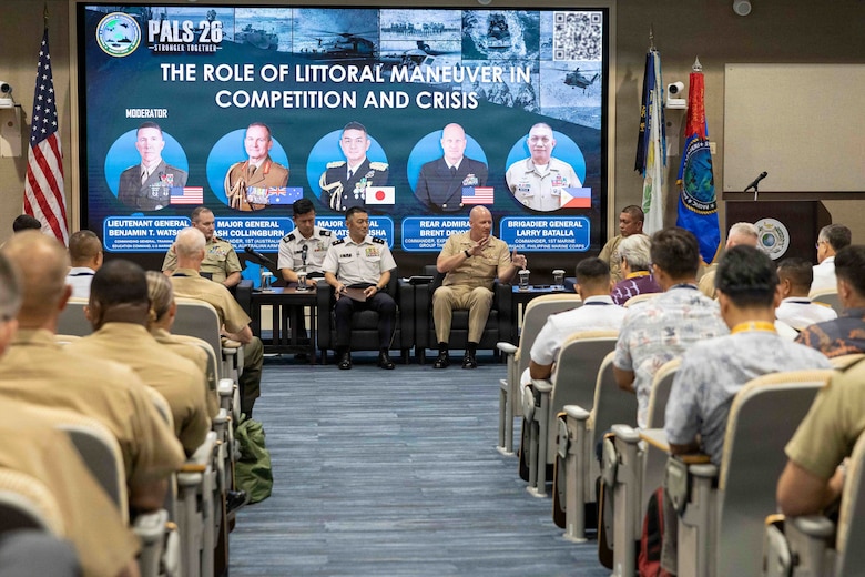 U.S. Navy Rear Adm. Brent Devore, center right, the commander of Expeditionary Strike Group 3, speaks to the audience during a panel on the role of littoral maneuver in competition and crisis at the Pacific Amphibious Leaders Symposium 2026 in Honolulu, Hawaii, June 16, 2026. Bringing together experts and leaders from across the Indo-Pacific, PALS fosters collaboration among allied and partner amphibious and maritime forces to share knowledge and recent operational insights. This year was the 12th iteration of the symposium and hosted senior leaders from 25 participating nations who are committed to a free and open Indo-Pacific, with the objective of strengthening and developing regional relationships. (U.S. Marine Corps photo by Sgt. Jade K. Venegas)(A portion of this photo has been blurred for security purposes.)