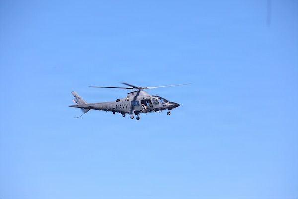 An Armed Forces of the Philippines AW109 naval helicopter flies over Sentinel-class fast response cutter USCGC Charles Moulthrope (WPC 1141) during a Maritime Cooperative Activity. U.S. 7th Fleet routinely operates with the Armed Forces of the Philippines and partners and allies through MCAs to continually develop, exercise and enhance multi-domain tactical interoperability to uphold peace and security in the region. (Courtesy photo by U.S. Coast Guard)