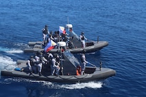 Members of the Armed Forces of the Philippines conduct small-boat operations with U.S. Coast Guard Sentinel-class fast response cutters USCGC Emlen Tunnell (WPC 1145) and Charles Moulthrope (WPC 1141) during a Maritime Cooperative Activity. U.S. 7th Fleet routinely operates with the Armed Forces of the Philippines and partners and allies through MCAs to continually develop, exercise and enhance multi-domain tactical interoperability to uphold peace and security in the region. (Courtesy photo by U.S. Coast Guard)