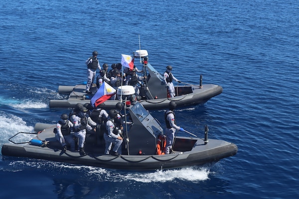 Members of the Armed Forces of the Philippines conduct small-boat operations with U.S. Coast Guard Sentinel-class fast response cutters USCGC Emlen Tunnell (WPC 1145) and Charles Moulthrope (WPC 1141) during a Maritime Cooperative Activity. U.S. 7th Fleet routinely operates with the Armed Forces of the Philippines and partners and allies through MCAs to continually develop, exercise and enhance multi-domain tactical interoperability to uphold peace and security in the region. (Courtesy photo by U.S. Coast Guard)