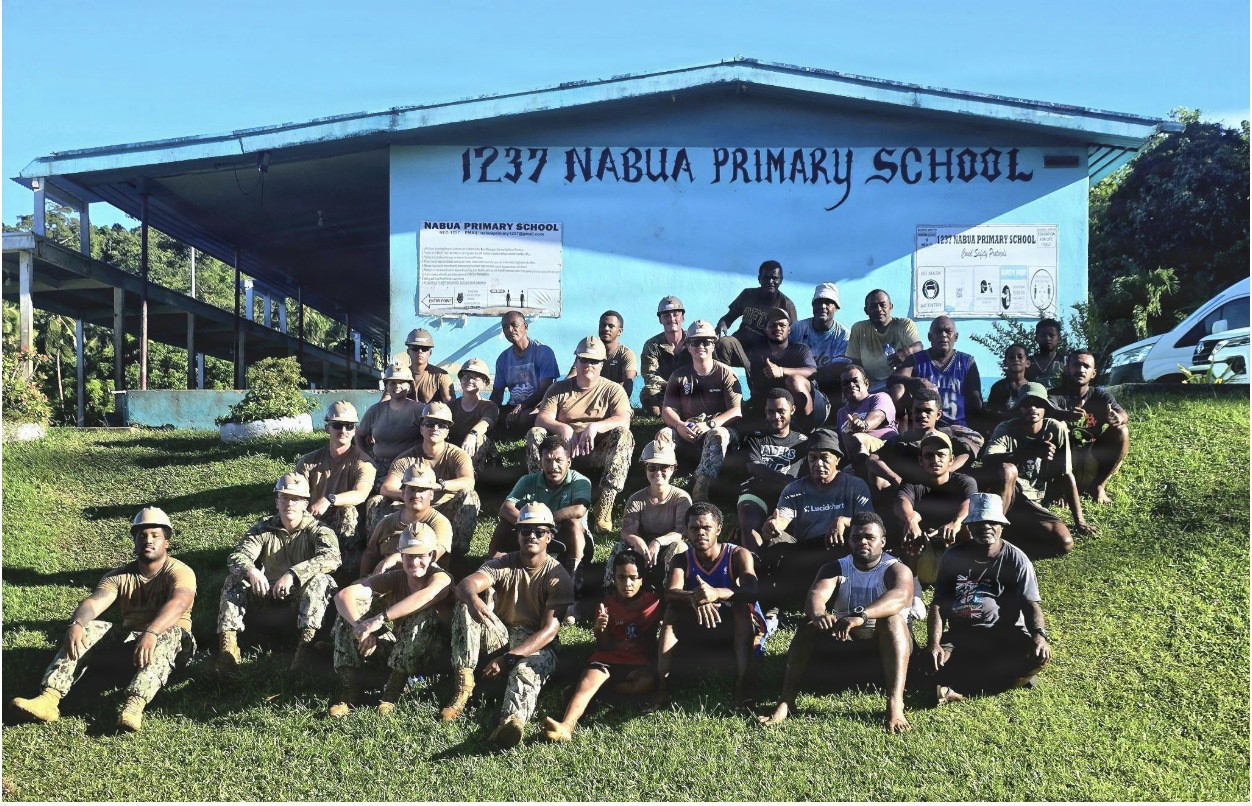 SAVUSAVU, Fiji (April 27, 2026) – U.S. Navy Sailors, assigned to Naval Mobile Construction Battalion (NMCB) 1, sit with Nabua villagers in front of a primary school during construction efforts for the Nabua Schoolhouse Project as part of Pacific Partnership 2026 in Savusavu, Fiji, April 27, 2026.