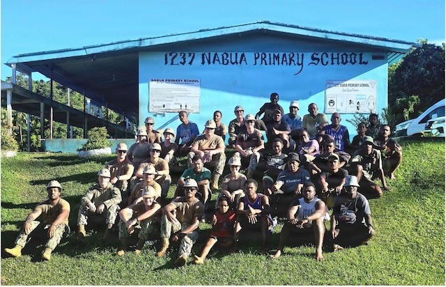 SAVUSAVU, Fiji (April 27, 2026) – U.S. Navy Sailors, assigned to Naval Mobile Construction Battalion (NMCB) 1, sit with Nabua villagers in front of a primary school during construction efforts for the Nabua Schoolhouse Project as part of Pacific Partnership 2026 in Savusavu, Fiji, April 27, 2026.