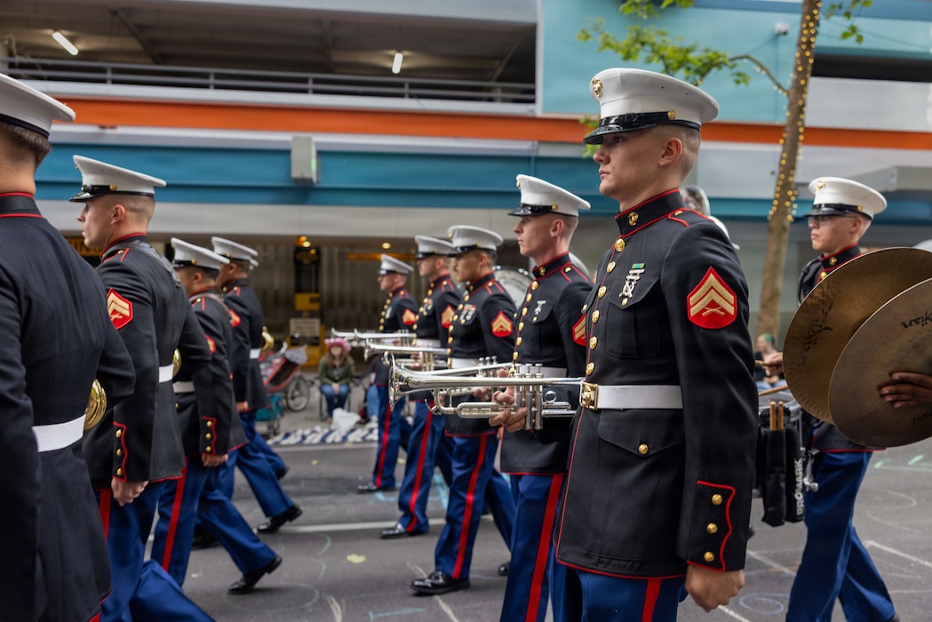 U.S. Marines with the 1st Marine Division Band, march in the Grand Floral Starlight Parade during the Portland Rose Festival Fleet Week, in Portland, Oregon, June 6, 2026. The Portland Rose Festival was a part of Portland Fleet Week and provided the opportunity to build community relations for the citizens of Oregon to interact with Marines, Sailors and Coast Guardsmen. (U.S. Marine Corps photo by Cpl. Stella Tedesco)