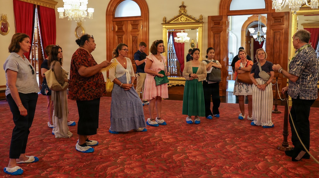 International military spouses tour Iolani Palace during the spouse program as part of the Pacific Amphibious Leaders Symposium 2026 in Honolulu, Hawaii, June 17, 2026. The relationships strengthened at PALS contribute to regional stability and crisis response capabilities, supporting mutual international interests. This year's symposium hosted senior leaders from 25 participating nations who are committed to a free and open Indo-Pacific, with the objective of strengthening and developing regional relationships. (U.S. Marine Corps photo by Lance Cpl. Audrie Nelson)