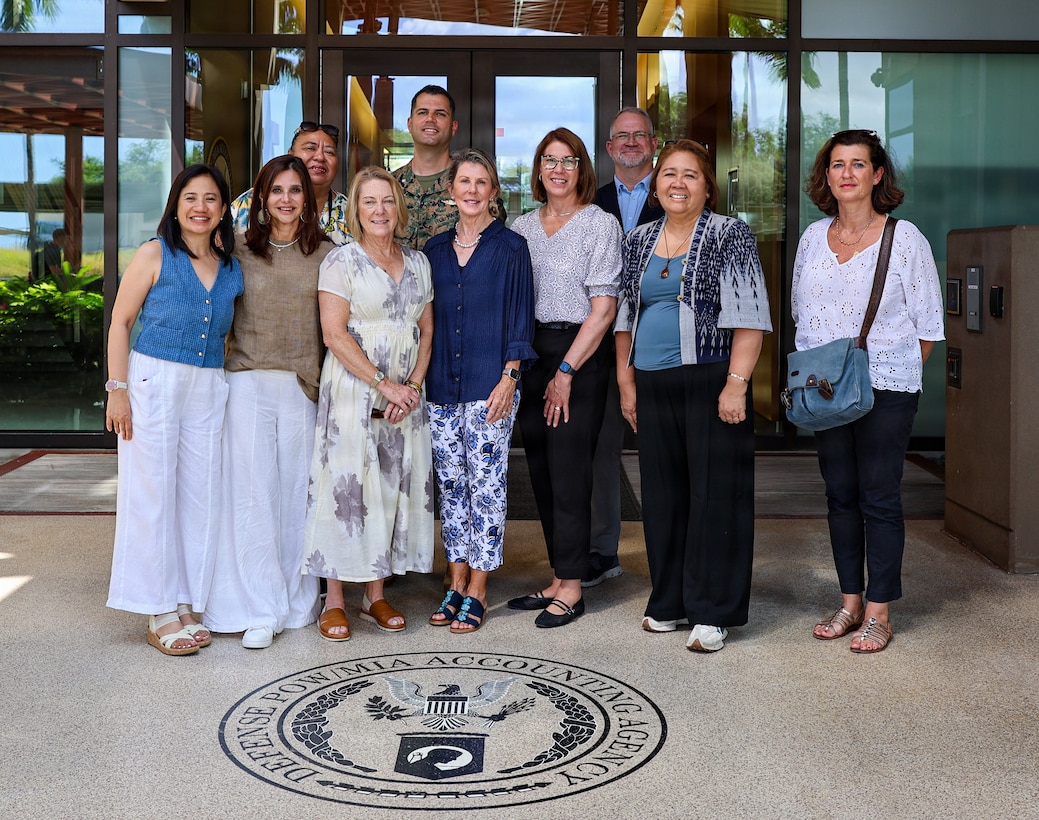 International military spouses pose for a group photo at the Defense POW/MIA Accounting Agency during the spouse program as part of the Pacific Amphibious Leaders Symposium 2026 at Joint Base Pearl Harbor-Hickam, Hawaii, June 18, 2026. The relationships strengthened at PALS contribute to regional stability and crisis response capabilities, supporting mutual international interests. This year's symposium hosted senior leaders from 25 participating nations who are committed to a free and open Indo-Pacific, with the objective of strengthening and developing regional relationships. (U.S. Marine Corps photo by Lance Cpl. Audrie Nelson)