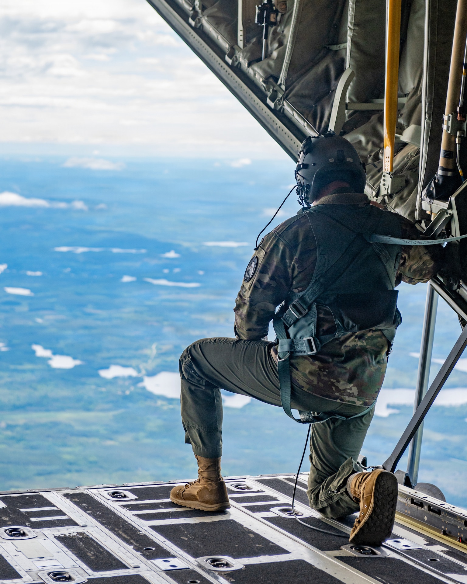 U.S. Air Force Senior Airman Andrew Hudson, a loadmaster assigned to the 123rd Airlift Wing, Kentucky Air National Guard, kneels on the open ramp of a C-130J Super Hercules aircraft in preparation for a NATO Allied aircraft formation over Finland as part of exercise Ramstein Flag, June 16, 2026. The 123rd AW is providing tactical airlift support to NATO Allies throughout the month of June in support of Ramstein Flag 2026, an Allied Air Command large-scale, multi-location and joint operating area exercise with 18 participating nations and more than 200 aircraft. (U.S. Air National Guard photo by Senior Airman Annaliese Billings)
