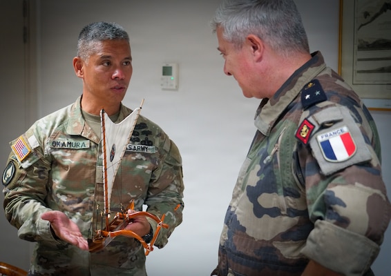 Maj. Gen. Lance Okamura, deputy commanding general of U.S. Army Pacific–Homeland Affairs, presents a traditional Hawaiian voyaging canoe to Rear Adm. Guillaume Pinget, commander of the French Armed Forces in French Polynesia, during a gift exchange following a distinguished visitor day for Exercise MARARA 26 in Tahiti, French Polynesia, June 16, 2026.
