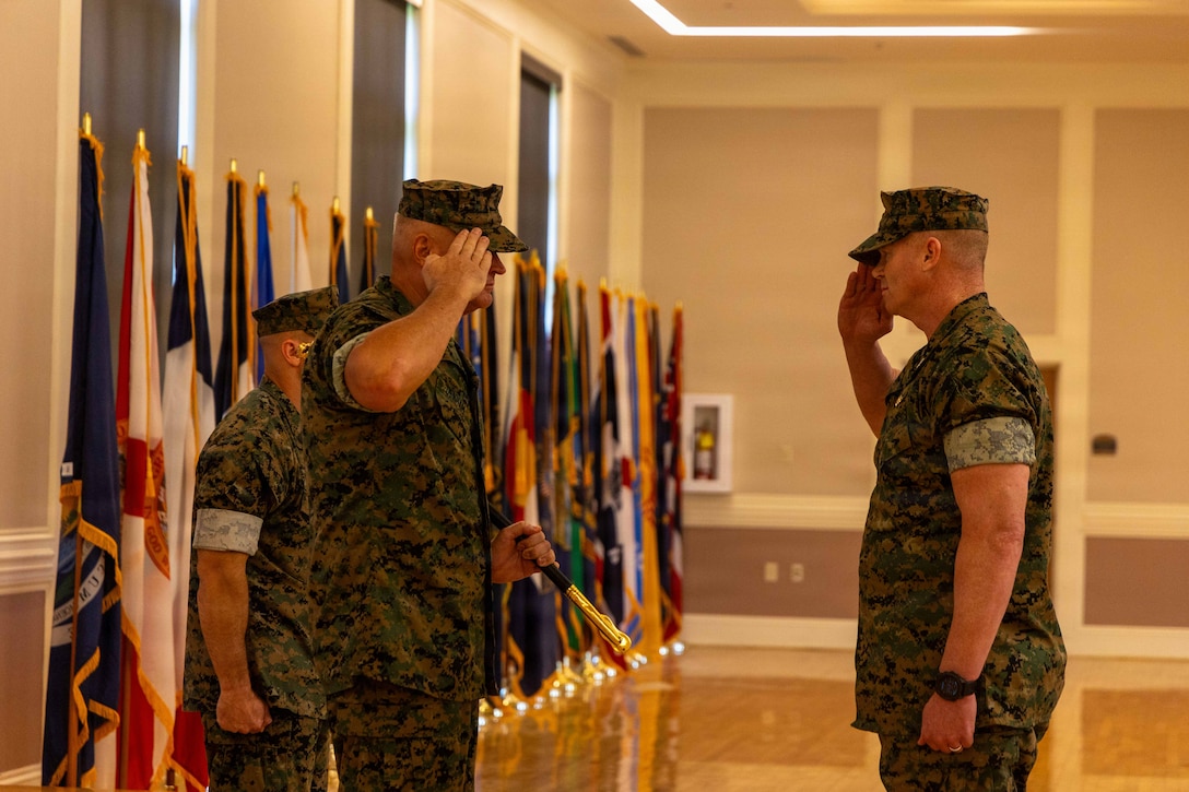 U.S. Marine Corps Sgt. Maj. Christopher Denham, outgoing sergeant major of the 22nd Marine Expeditionary Unit, left, salutes Col. Thomas Trimble, commanding officer of the 22nd MEU, right, during a relief and appointment ceremony on Marine Corps Base Camp Lejeune, North Carolina, June 12, 2026. The relief and appointment ceremony represents the transfer of responsibility and accountability from the outgoing to the incoming sergeant major.  (U.S. Marine Corps photo by Sgt. Tanner Bernat)
