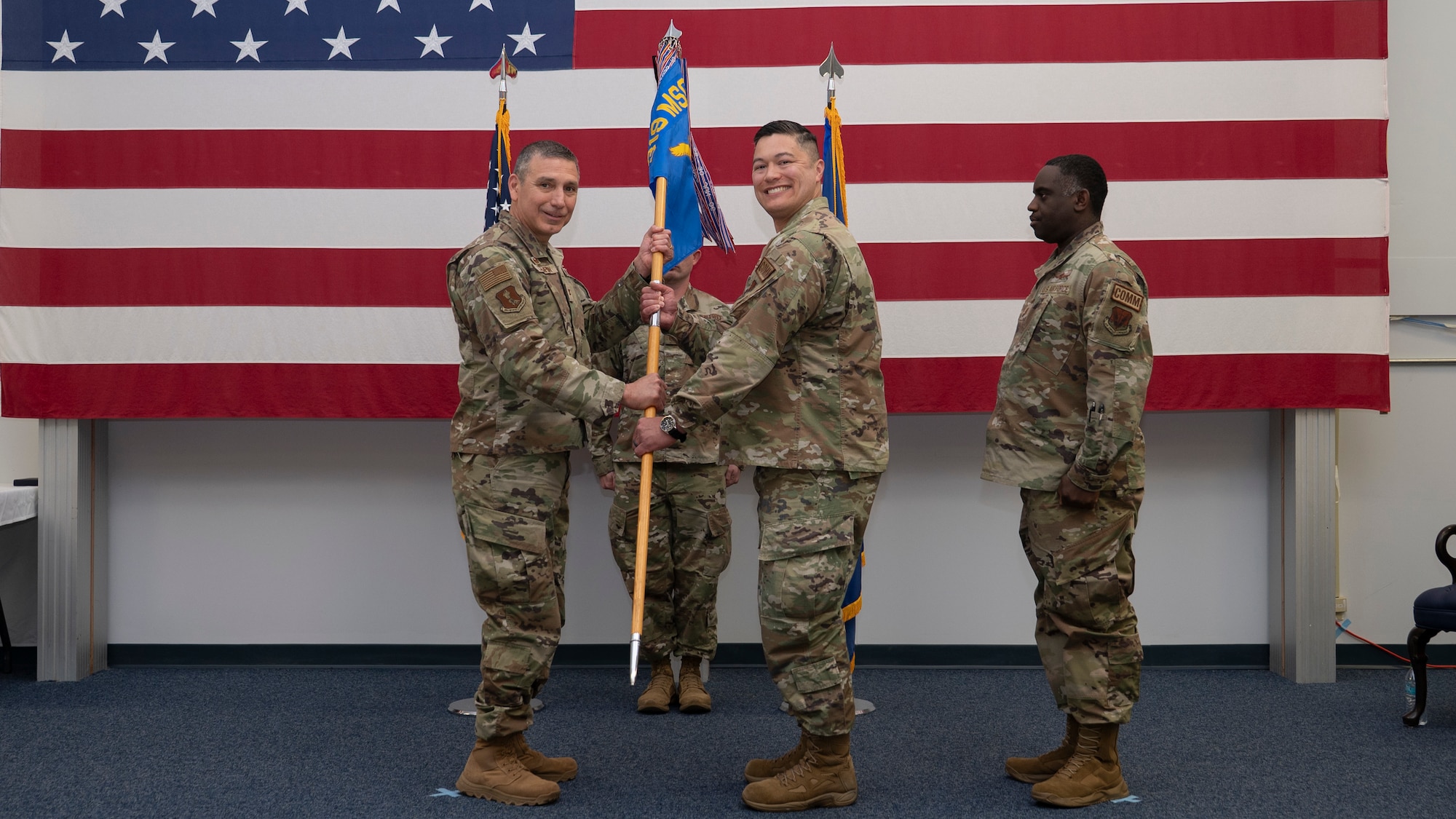 Outgoing commander gives guidon to U.S. Air Force Col. Reynaldo Champion.