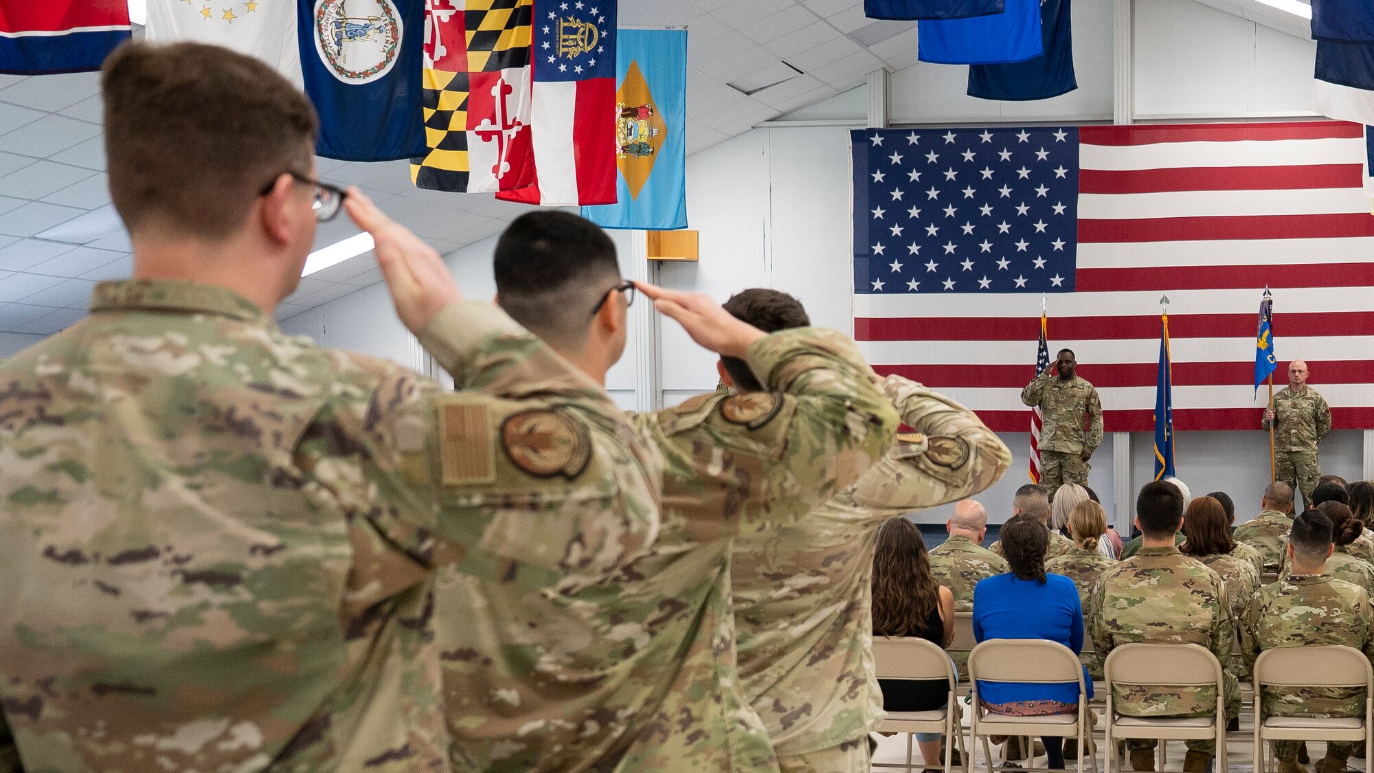 Airmen salute incoming commander at a change of command ceremony.