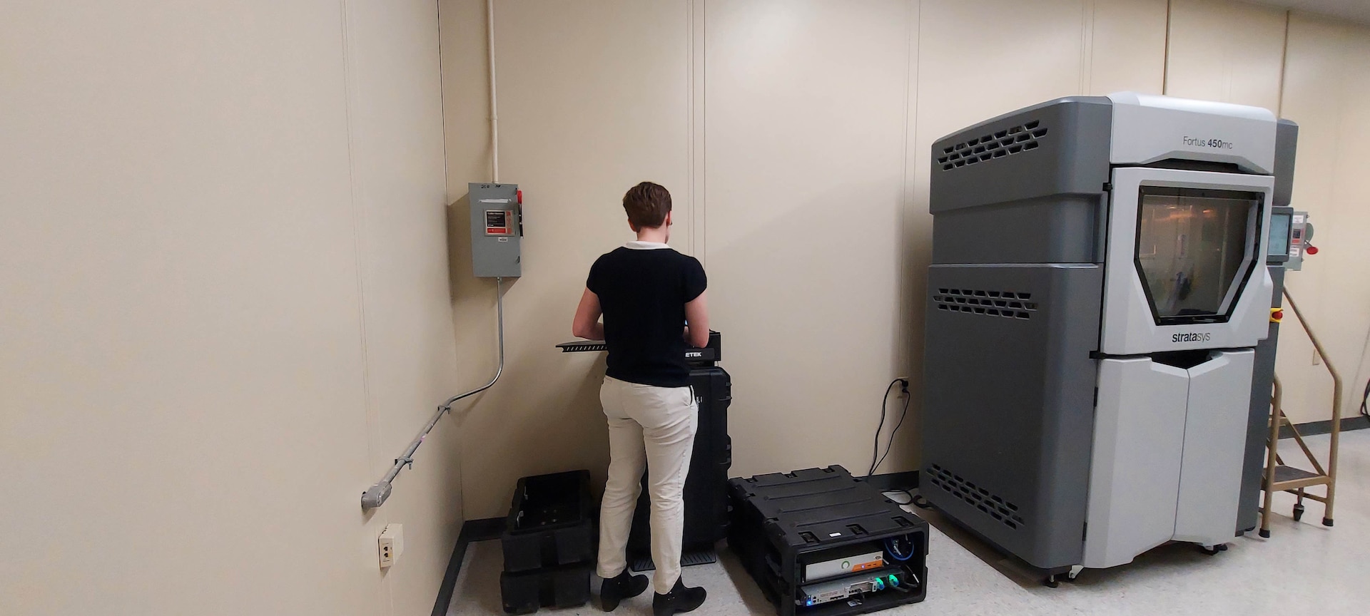 A woman watches a computer monitor.