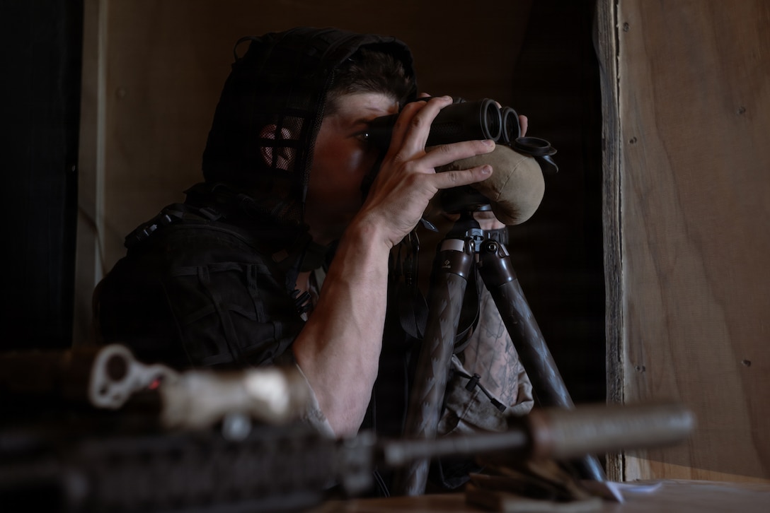 A U.S. Marine Corps scout with 2nd Battalion, 24th Marines, 4th Marine Division, observes simulated enemy movements from a listening and observing post as part of an information and intelligence integration course during Integrated Training Exercise 3-26, Marine Corps Air Ground Combat Center Twentynine Palms, California, June 8, 2026. ITX is designed to generate combat readiness and ensure the Reserve Component provides critical strategic depth to the Total Force. From complex combined arms maneuvers to all-domain integration, these Marines are proving that they are ready to augment, reinforce, and fight alongside the active component at a moment's notice. (U.S. Marine Corps photo by Cpl. Van Hoang)