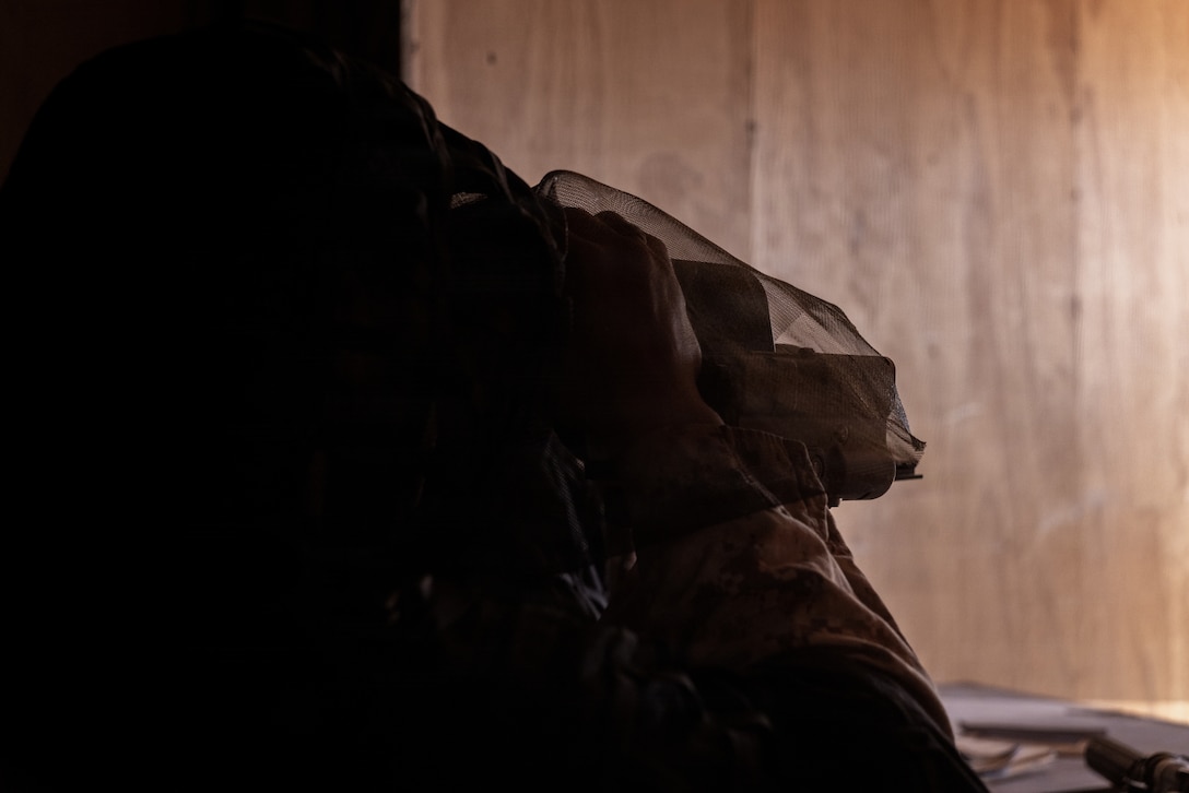 A U.S. Marine Corps scout with 2nd Battalion, 24th Marines, 4th Marine Division, observes simulated enemy movements from a listening and observing post as part of an information and intelligence integration course during Integrated Training Exercise 3-26, Marine Corps Air Ground Combat Center Twentynine Palms, California, June 8, 2026. ITX is designed to generate combat readiness and ensure the Reserve Component provides critical strategic depth to the Total Force. From complex combined arms maneuvers to all-domain integration, these Marines are proving that they are ready to augment, reinforce, and fight alongside the active component at a moment's notice. (U.S. Marine Corps photo by Cpl. Van Hoang)