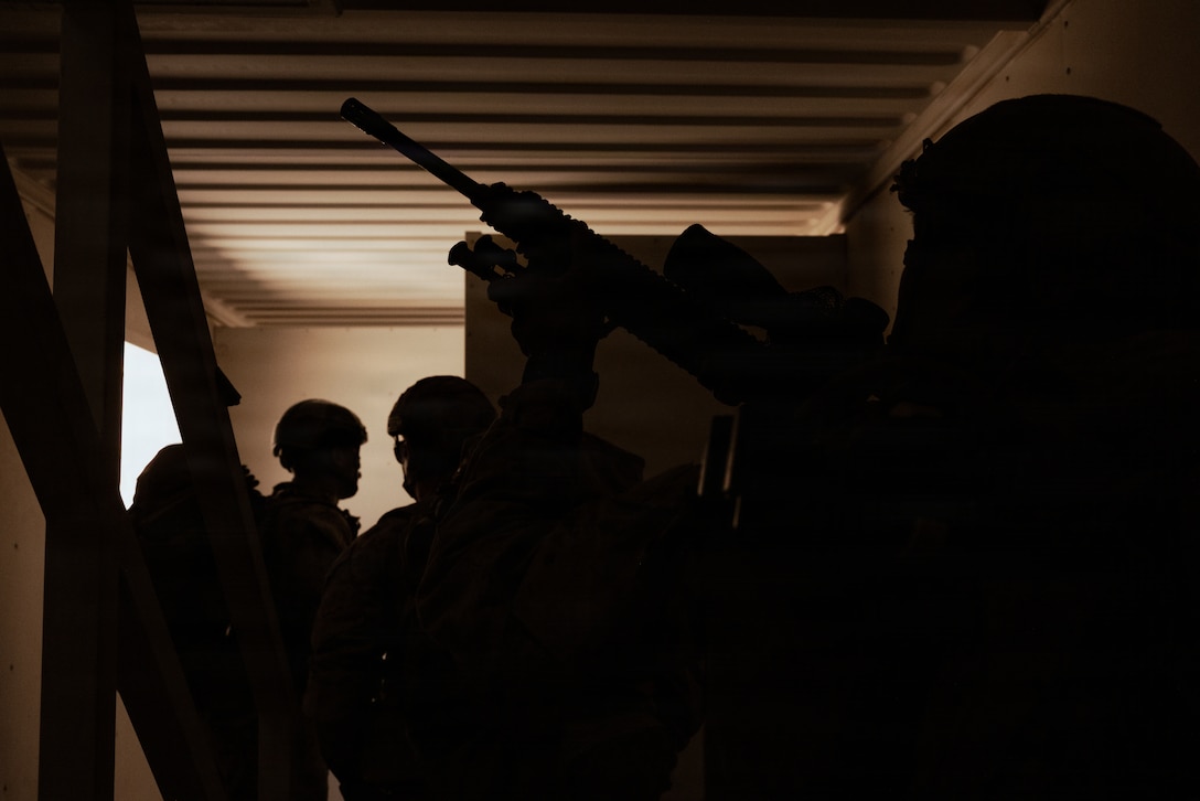 U.S. Marine Corps scouts with 2nd Battalion, 24th Marines, 4th Marine Division, clear a building in a military operation on urban terrain town as part of an information and intelligence integration course during Integrated Training Exercise 3-26, Marine Corps Air Ground Combat Center Twentynine Palms, California, June 8, 2026. ITX is designed to generate combat readiness and ensure the Reserve Component provides critical strategic depth to the Total Force. From complex combined arms maneuvers to all-domain integration, these Marines are proving that they are ready to augment, reinforce, and fight alongside the active component at a moment's notice. (U.S. Marine Corps photo by Cpl. Van Hoang)