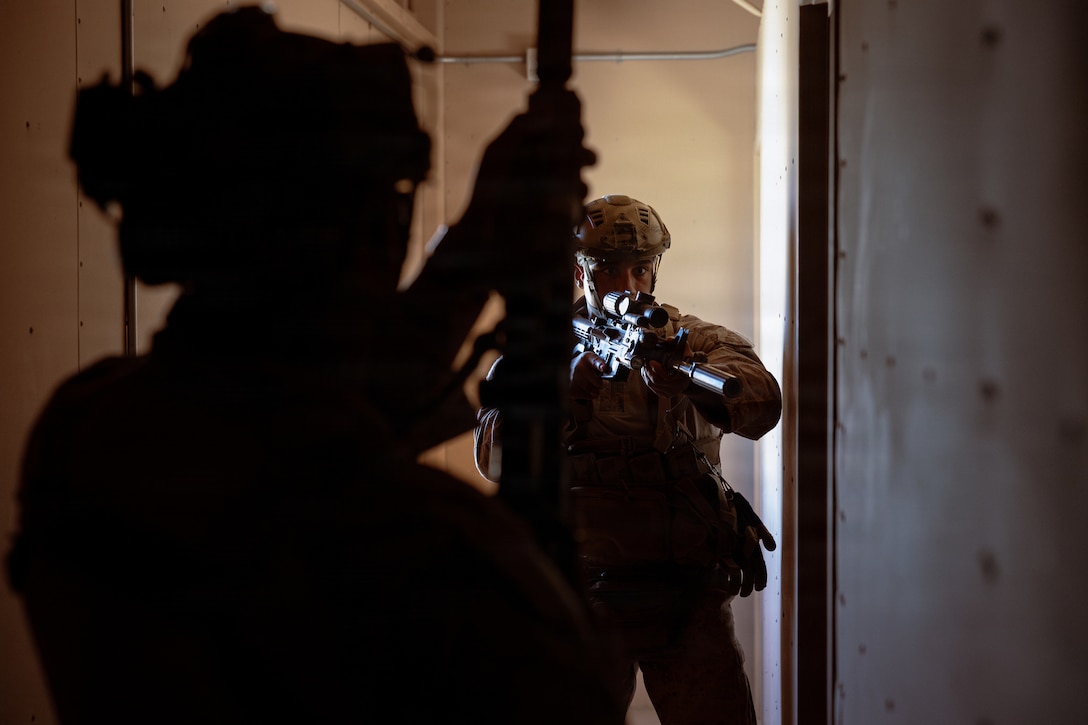 U.S. Marine Corps scouts with 2nd Battalion, 24th Marines, 4th Marine Division, prepare to enter and clear a room in a military operation on urban terrain town as part of an information and intelligence integration course during Integrated Training Exercise 3-26, Marine Corps Air Ground Combat Center Twentynine Palms, California, June 8, 2026. ITX is designed to generate combat readiness and ensure the Reserve Component provides critical strategic depth to the Total Force. From complex combined arms maneuvers to all-domain integration, these Marines are proving that they are ready to augment, reinforce, and fight alongside the active component at a moment's notice. (U.S. Marine Corps photo by Cpl. Van Hoang)