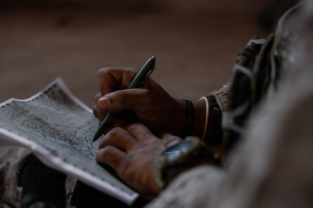 A U.S. Marine Corps scout with 2nd Battalion, 24th Marines, 4th Marine Division, assesses buildings to create a listening and observing post as part of an information and intelligence integration course during Integrated Training Exercise 3-26, Marine Corps Air Ground Combat Center Twentynine Palms, California, June 8, 2026. ITX is designed to generate combat readiness and ensure the Reserve Component provides critical strategic depth to the Total Force. From complex combined arms maneuvers to all-domain integration, these Marines are proving that they are ready to augment, reinforce, and fight alongside the active component at a moment's notice. (U.S. Marine Corps photo by Cpl. Van Hoang)