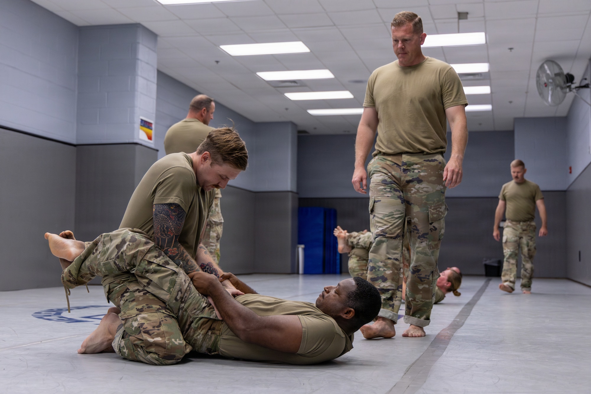 U.S. Air Force Master Sgt. Daniel K. Ayers, 145th Security Forces Squadron (SFS) unit training manager, right, observes Tech. Sgt. John T. Leonard, 145th SFS fire team lead, top, and Tech. Sgt. David C. Mobley, 145th SFS fire team lead, bottom, perform the close-guard position at the Charlotte-Mecklenburg Police Department Training Academy, Charlotte, N.C., May 2, 2026.