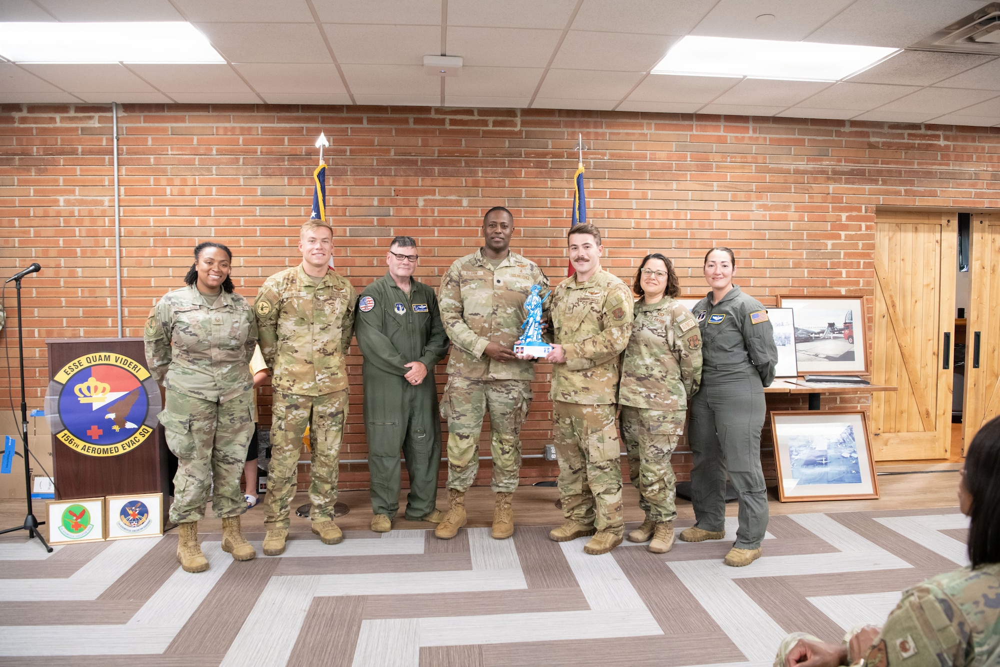 156th Aeromedical Evacuation Squadron full-time staff accepts an award from U.S. Air Force SMSgt Michael McBride, Aeromedical Evacuation Functional Area Manager, National Guard Bureau, during an emblem dedication ceremony on June 6, 2026, at the Charlotte Air National Guard base, N.C.