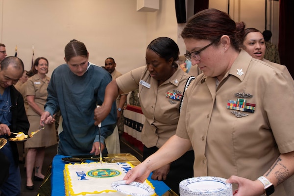PORTSMOUTH, Va. (June 17, 2026) Hospital Corpsman 1st Class Venessa Anzures, and Hospital Corpsman 1st Class Ariel Kent-LeBlanc, both assigned to Navy Medicine Readiness Training Command (NMRTC) Portsmouth, hand out cake during a ceremony for the hospital corpsman's 128th birthday at Naval Medical Center Portsmouth (NMCP), June 17, 2026. NMCP is the U.S. Navy’s premiere healthcare facility, having supported the maritime readiness of the U.S. Navy’s and U.S. Marine Corps’ forward-deployed units with high-quality medical care for nearly 200 years. NMRTC Portsmouth trains a staff of over 4,000 enlisted, commissioned, and civilian medical personnel across multiple specialties to provide high-quality medical care to patients at NMCP’s facilities and branch health clinics. (U.S. Navy photo by Mass Communication Specialist 2nd Class Thomas Boatright)