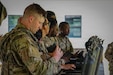 Sgt. Conner Bowers, noncommissioned officer, 390th MP Battalion, 200th MP 
Command, inspects the Wingman ruggedized drone detector during Operation 
Sentinel Justice 26 at Camp Shelby, Miss., June 12, 2026. The Wingman, assessed by 
the 75th U.S. Army Reserve Innovation Command, pairs with the Pitbull device to 
create a Soldier-borne drone countermeasure. (Photo by Sgt. 1st Class Sam Hartley, 
75th U.S. Army Reserve Innovation Command)