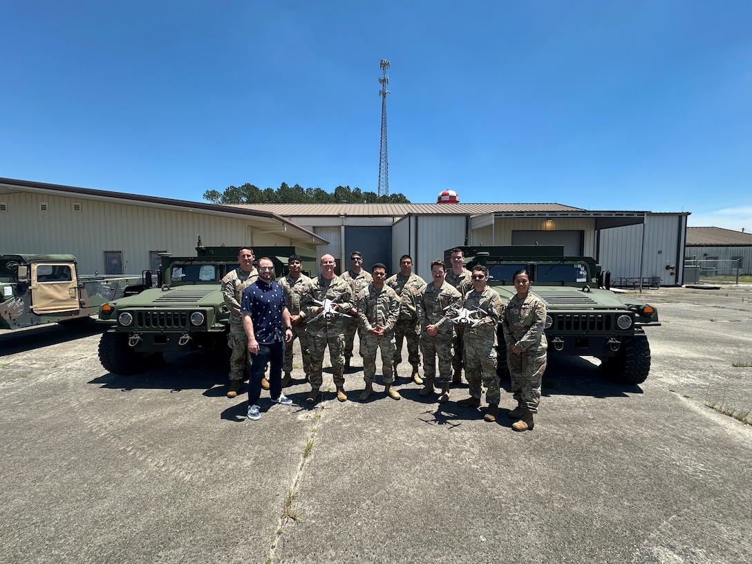 A group of U.S. Army soldiers stand together for a photo with Jeff Beaudoin, DCMA Mission Applications Division Information Technology Director and a member of the DCMA Blue List team.