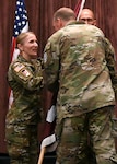 Brig. Gen. James “Jamie” Burk, Commanding General of Medical Readiness Command, East, passes the Fort Meade Medical Department Activity unit colors to Col. Elizabeth "Betsy" A. DeSitter, incoming commander of the Meade MEDDAC and director of Kimbrough Ambulatory Care Center