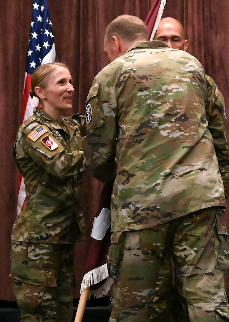 Brig. Gen. James “Jamie” Burk, Commanding General of Medical Readiness Command, East, passes the Fort Meade Medical Department Activity unit colors to Col. Elizabeth "Betsy" A. DeSitter, incoming commander of the Meade MEDDAC and director of Kimbrough Ambulatory Care Center