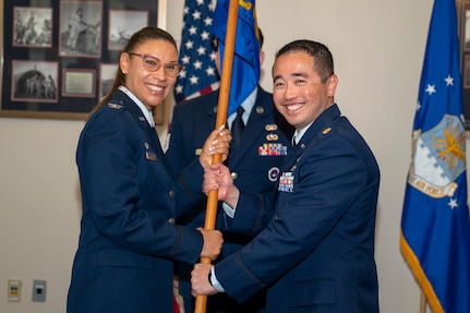 U.S. Air Force Col. Angelique Nelson, left, 11th Mission Support Group commander, presents the unit guidon to U.S. Air Force Maj. Jonathan G. Yeap, 11th Contracting Squadron incoming commander, during the 11th CONS change of command ceremony at Joint Base Anacostia-Bolling, Washington, D.C., June 17, 2026. The 11th CONS supports 11th Wing and its 75 JBAB mission partners in acquisition management. (U.S. Air Force photo by Senior Airman Shanel Toussaint)