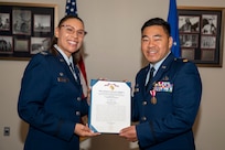 U.S. Air Force Col. Angelique Nelson, 11th Mission Support Group commander, left, presents U.S. Air Force Maj. Brandon K. Kido, 11th Contracting Squadron outgoing commander, with a Meritorious Service Medal during the 11th CONS change of command ceremony at Joint Base Anacostia-Bolling, Washington, D.C., June 17, 2026. Kido was responsible for leading the 11th CONS in their support to the 11th Wing, 75 JBAB mission partners and more than 17,000 military and civilian employees and their families throughout the National Capital Region. (U.S. Air Force photo by Senior Airman Shanel Toussaint)