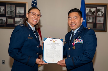 U.S. Air Force Col. Angelique Nelson, 11th Mission Support Group commander, left, presents U.S. Air Force Maj. Brandon K. Kido, 11th Contracting Squadron outgoing commander, with a Meritorious Service Medal during the 11th CONS change of command ceremony at Joint Base Anacostia-Bolling, Washington, D.C., June 17, 2026. Kido was responsible for leading the 11th CONS in their support to the 11th Wing, 75 JBAB mission partners and more than 17,000 military and civilian employees and their families throughout the National Capital Region. (U.S. Air Force photo by Senior Airman Shanel Toussaint)