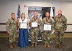 Leaders at the U.S. Army Medical Materiel Agency recognized three team members – Kellie Pugh, Maj. Jeremy Searles and Master Sgt. Ceasar Juan – for their induction into the Order of Military Medical Merit, or O2M3, during a USAMMA awards ceremony May 27 at Fort Detrick, Maryland. Flanking the honorees are USAMMA Commander Col. Joselito “Joe” Lim and Sgt. Maj. Todd Brenecki, former USAMMA senior enlisted leader.