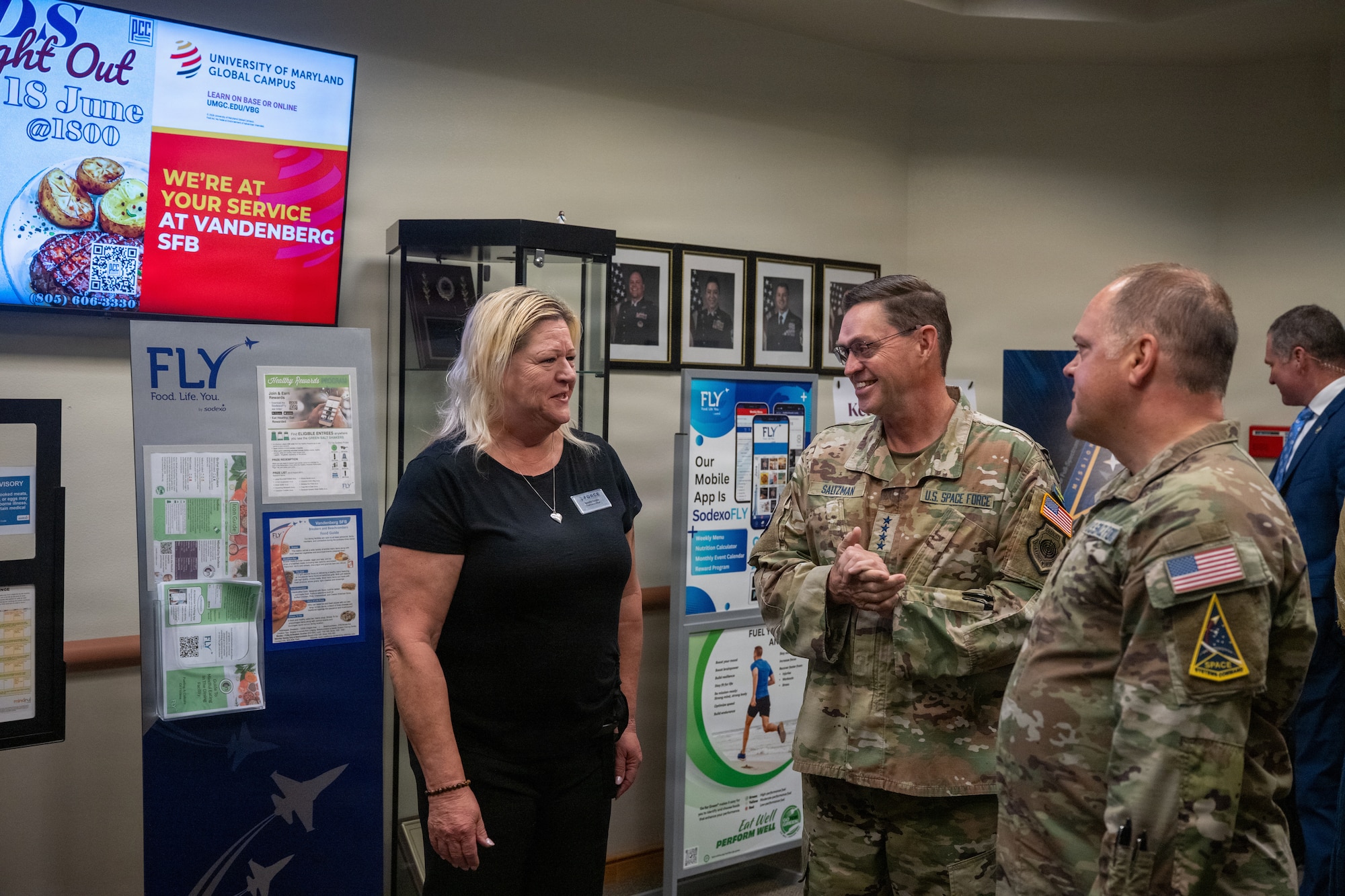 Two Space Force officers greet the dining facility service officer at the entrance to the dining facility.
