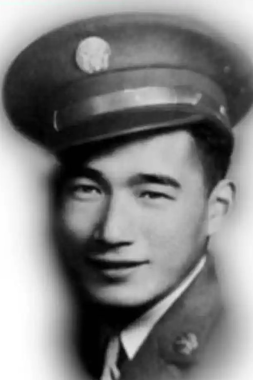 A black and white photo of a man wearing a military dress uniform and hat posing for a photo.