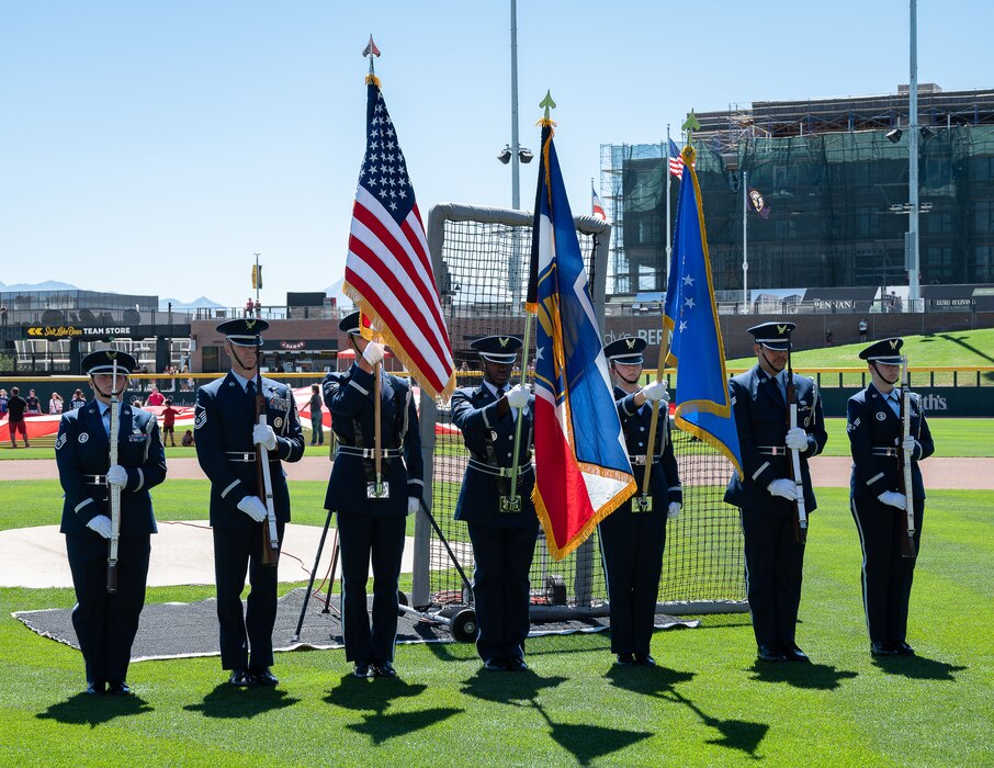 Members of a joint color guard composed of Utah National Guard and Hill Air Force Base service members present the colors during pregame ceremonies before an exhibition baseball game at The Ballpark at America First Square in South Jordan, Utah, June 13, 2025. The event brought together military members and community partners to promote resilience, mental health awareness and community support through the "In the Open: Strength Beyond the Uniform" initiative. (Utah National Guard photo by Master Sgt. Nicholas Perez)