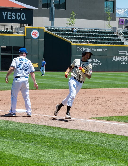 A Utah National Guard baseball player rounds first base during an exhibition game against Hill Air Force Base at The Ballpark at America First Square in South Jordan, Utah, June 13, 2025. The game followed the "In the Open: Strength Beyond the Uniform" resilience event, which promoted mental health awareness, community engagement and service member well-being. (Utah National Guard photo by Master Sgt. Nicholas Perez)