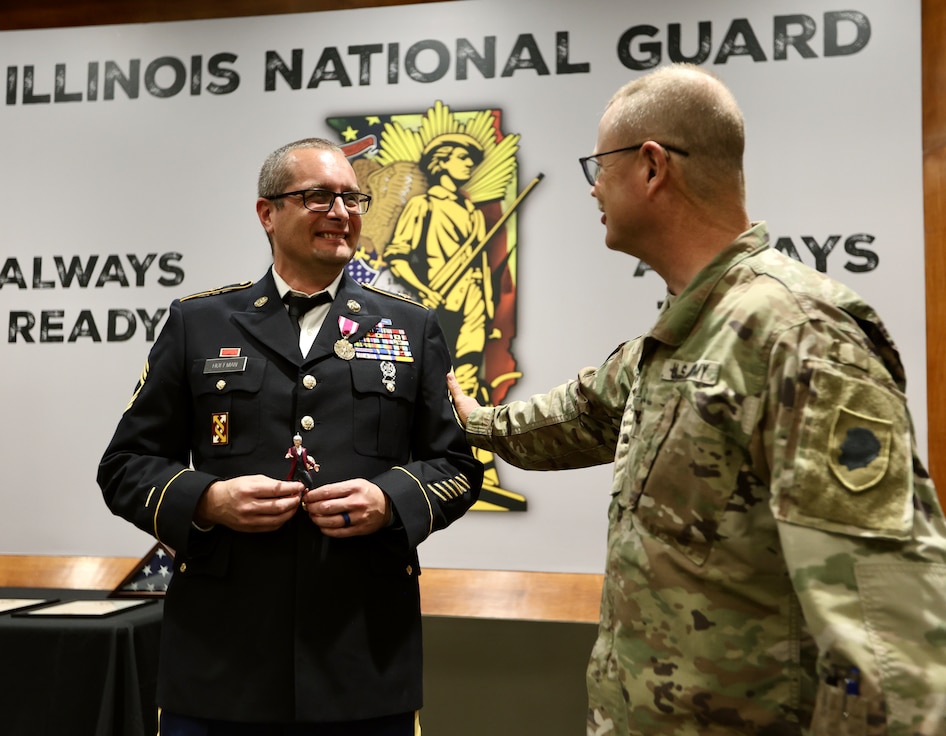 State Command Chaplain (Colonel) Steve Foster congratulates 1st Sgt. (ret.) Greg Hoffman career during Hoffman’s June 6 retirement ceremony on Camp Lincoln in Springfield, Illinois.