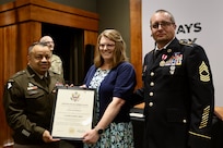 Brig. Gen. Jorge Fonseca, the Director of the Illinois National Guard Joint Staff, presents Jodi Hoffman with a Certificate of Appreciation signed by the U.S. Army Chief of Staff thanking her for her support of her husband, Illinois Army National Guard 1st Sgt. (ret.) Greg Hoffman, throughout his 27-year military career during Greg Hoffman’s June 6 retirement ceremony on Camp Lincoln in Springfield, Illinois.