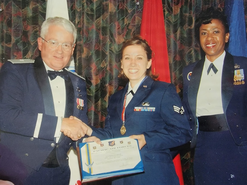 Then-Senior Airman Rebecca Velazquez receives recognition during her early years in the U.S. Air Force. Velazquez began her military career seeking adventure and opportunity, ultimately serving 27 years and retiring as the 183d Wing Command Chief, Illinois Air National Guard, before pursuing a new mission in mental health social work. (Courtesy photo)