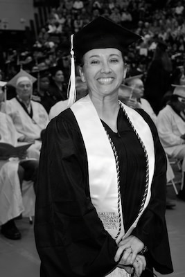 Chief Master Sgt. Rebecca Velazquez, then serving in the Illinois Air National Guard, poses during her graduation ceremony at Southern Illinois University Edwardsville. Velazquez earned a bachelor's degree in interdisciplinary studies with a focus on leadership, psychology and sociology, a milestone that helped inspire her pursuit of a Master of Social Work degree and a future career supporting veterans and underserved communities.