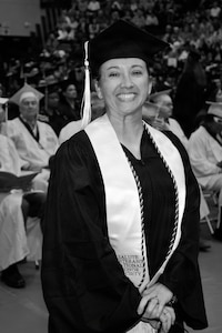 Chief Master Sgt. Rebecca Velazquez, then serving in the Illinois Air National Guard, poses during her graduation ceremony at Southern Illinois University Edwardsville. Velazquez earned a bachelor's degree in interdisciplinary studies with a focus on leadership, psychology and sociology, a milestone that helped inspire her pursuit of a Master of Social Work degree and a future career supporting veterans and underserved communities.