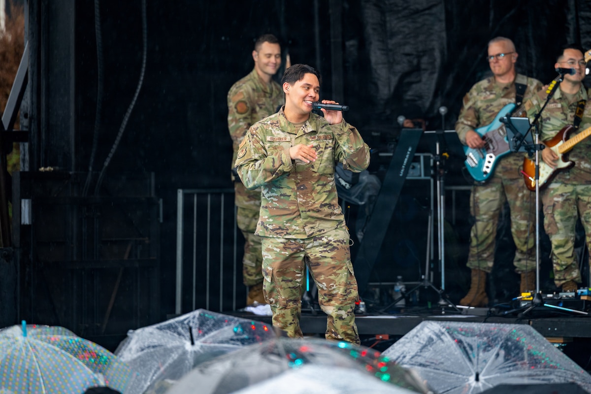 U.S. Air Force Senior Airman Keegan Bushouer, Pacific Trends lead vocalist, sings at American Day.