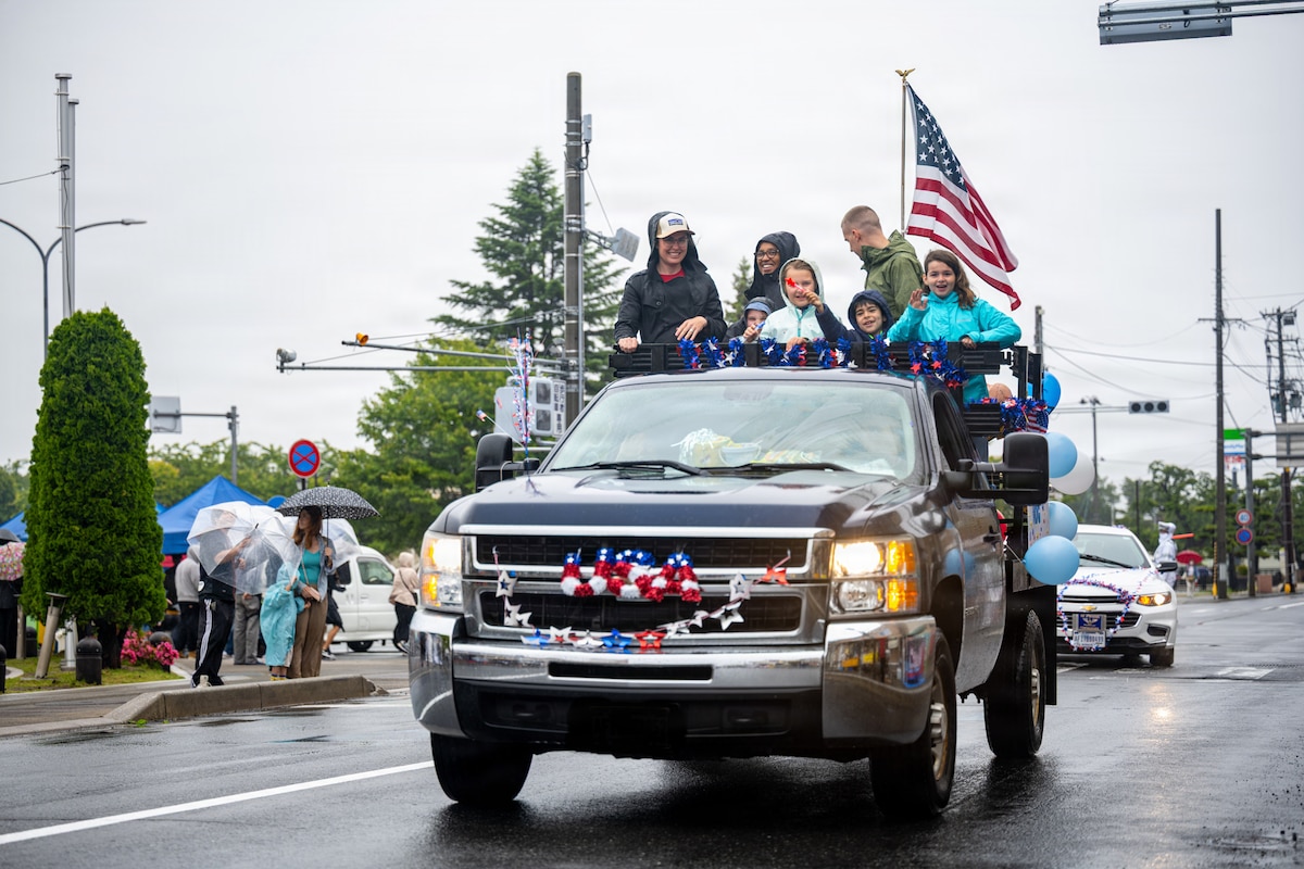 American Day parade participants greet the crowd.