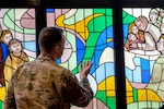 Air Force Maj. Joshua Rumsey, 501st Combat Support Wing chaplain, admires the chapel’s stained glass windows during an immersion tour at RAF Fairford, England, Feb. 9, 2024. Recent updates to Air Force uniform policies provide uniform guidance for chaplain and maternity uniforms.